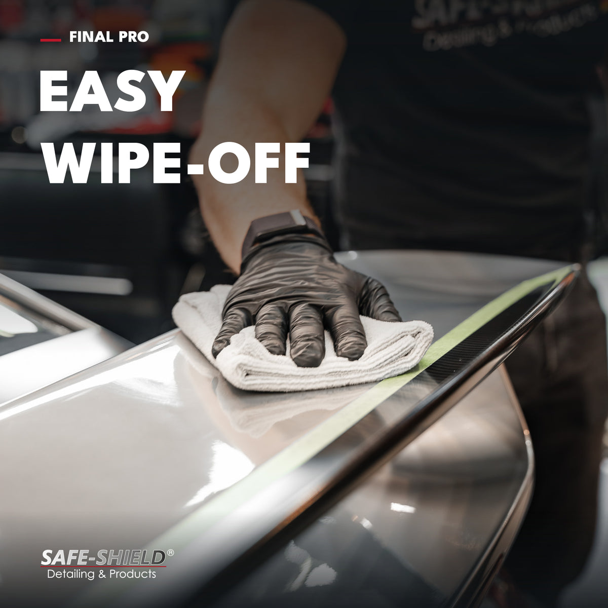 Gloved hand wiping off Final PRO ceramic coating from a car spoiler with a microfiber towel.